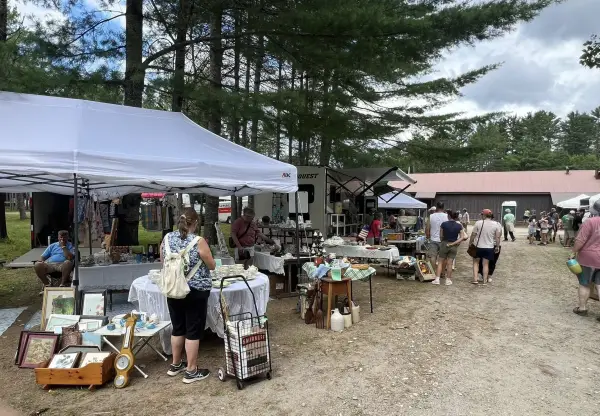 vendor at Brimfield and people shopping